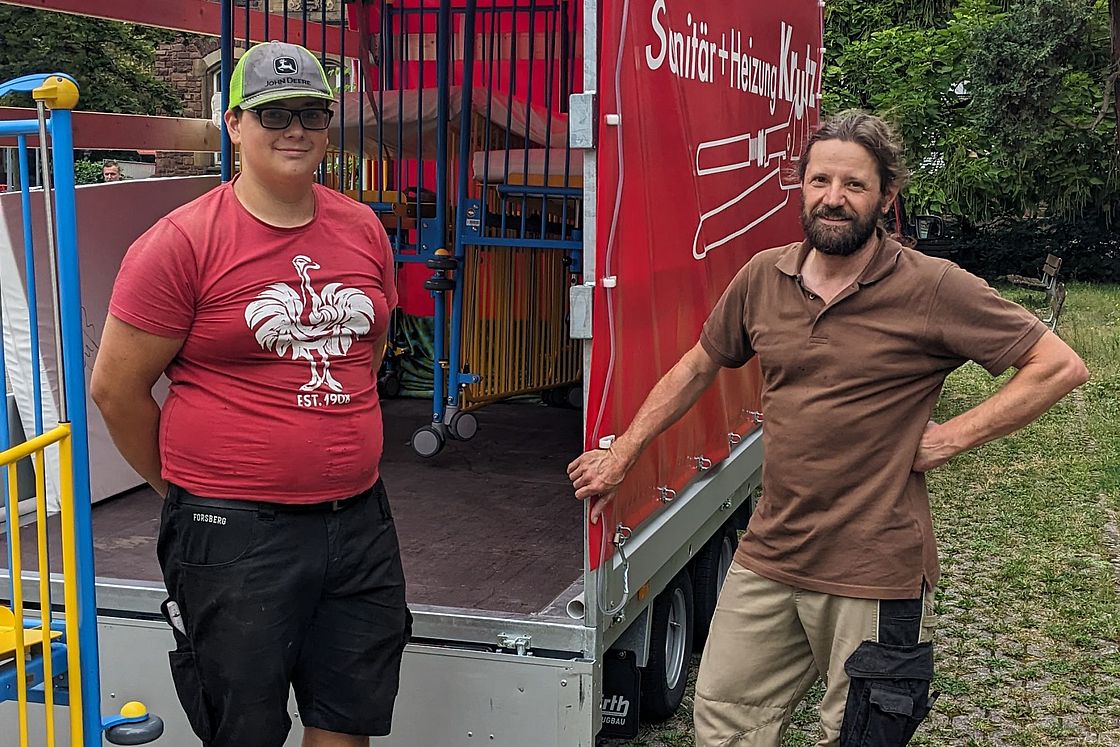 Das Bild zeigt Simon (li.) und Markus Albrecht vor einem LKW.